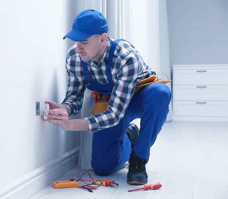 Electrician Repairing Power Socket In Room