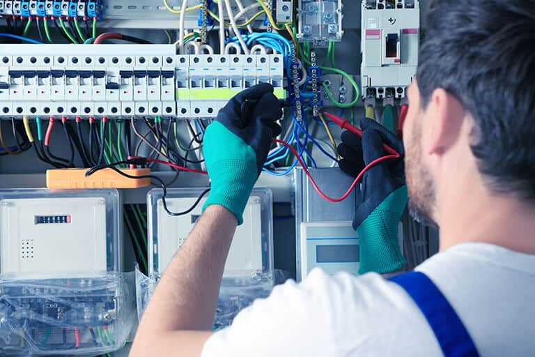 Electrician Checking Electricity Panel With Multimeter