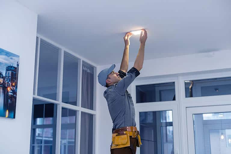 Electrician Is Installing Spotlights On The Ceiling