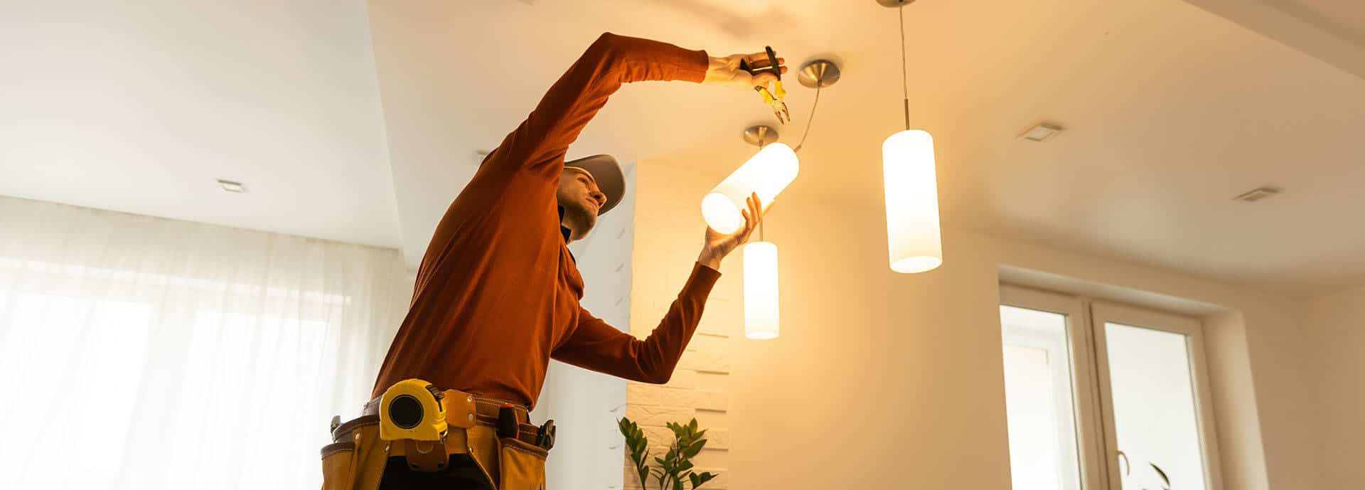 Electrician Repairing Ceiling Lamp Indoors Alt