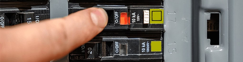 finger pointing at circuit breaker trip