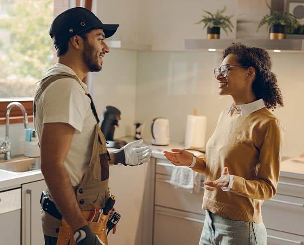 Electrician Consulting Homeowner In Kitchen