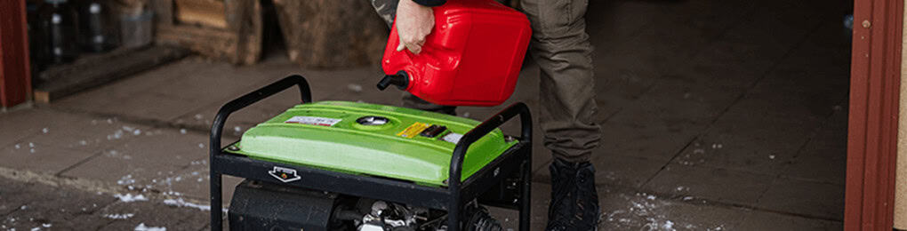 man pouring gasoline into portable home generator outdoors
