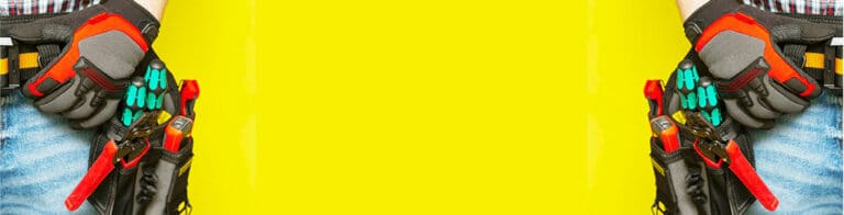 two electricians with tool belts standing in front of a yellow background