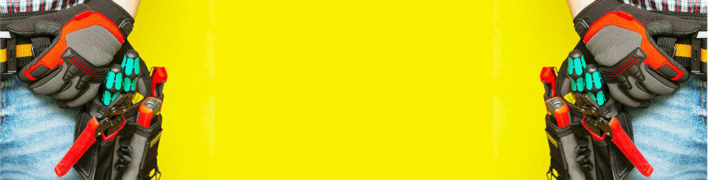 two electricians with tool belts standing in front of a yellow background